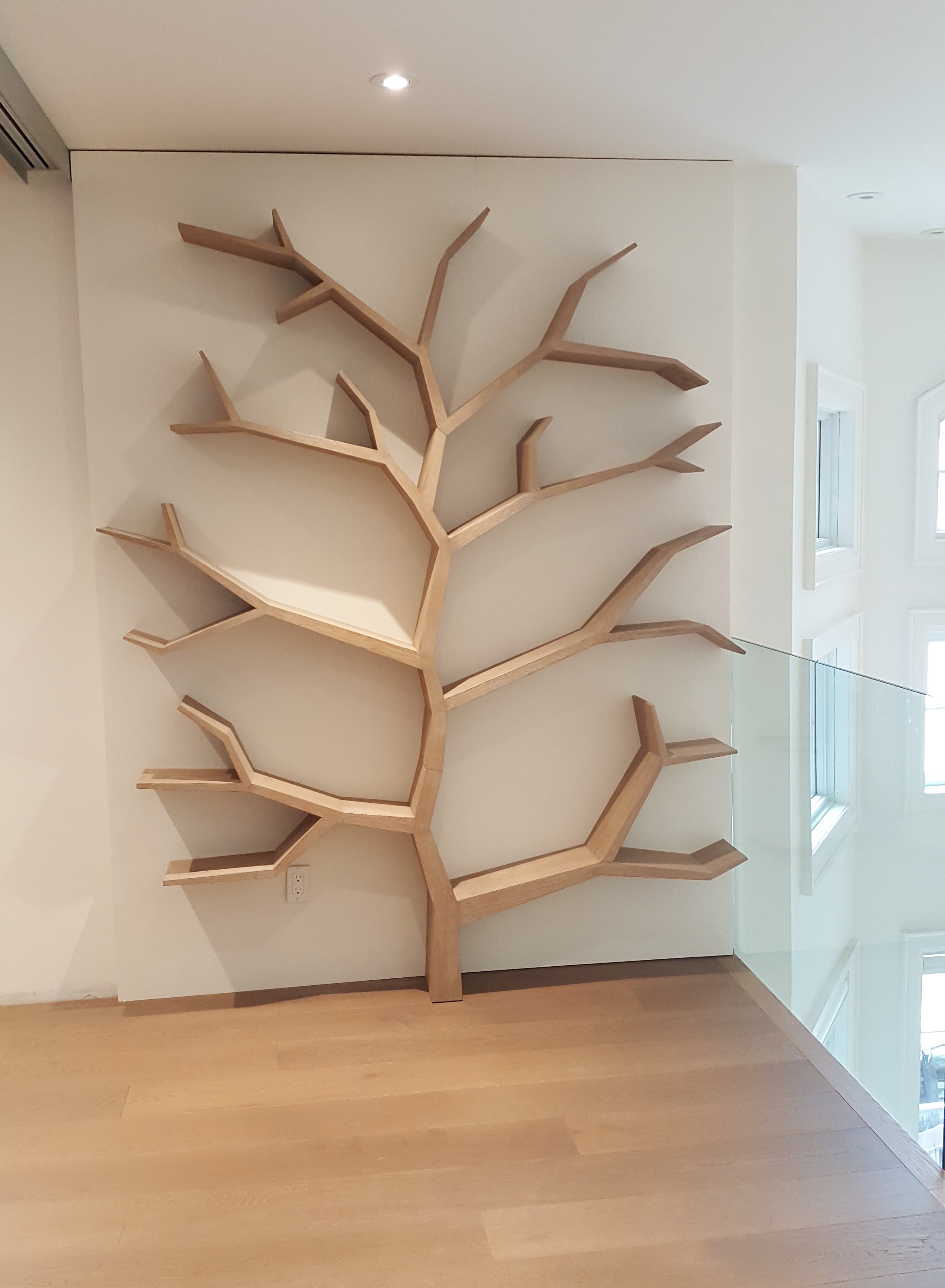 Tree Bookcase. A focal point for a new custom home that is essentially a sculpture for books.  Solid oak with a driftwood finish.