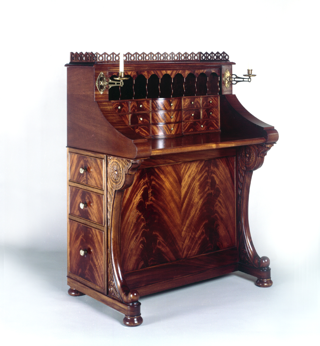 Davenport   An interpretation of the nineteenth century davenport style that includes hand carving, crotch mahogany veneer work, a slide-out desk, six drawers and a secret compartment.