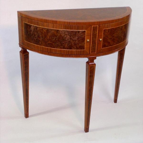 Demilune Table. Walnut with burl veneer work, holly string inlay and curved, pivoting doors make an inviting addition to the foyer of an antique furnished home.